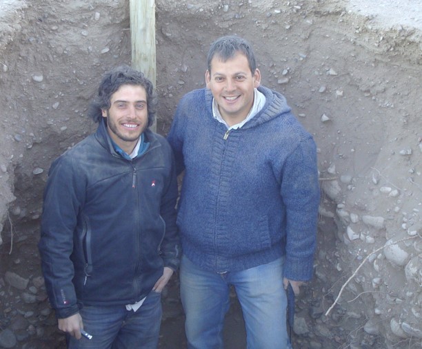 Two people in a soil trench