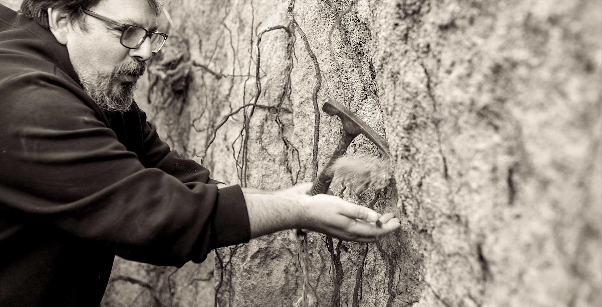 Pedro Parra sampling a granite soil profile with his hammer