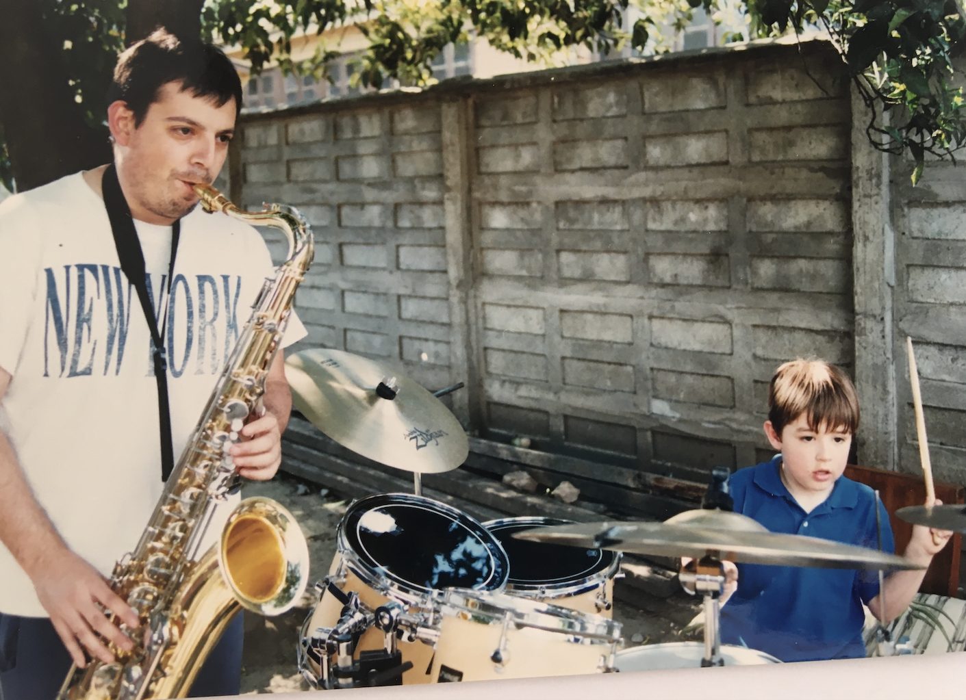 Pedro Parra playing saxophone with his son Diego on drums